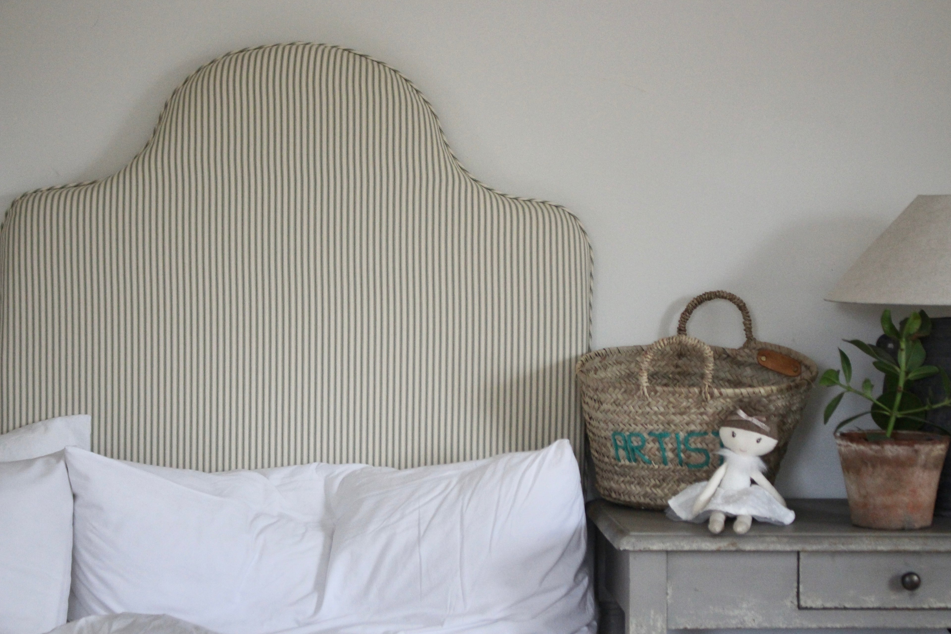 Close-up of Ian Mankin sage stripe fabric on handmade Margot single headboard