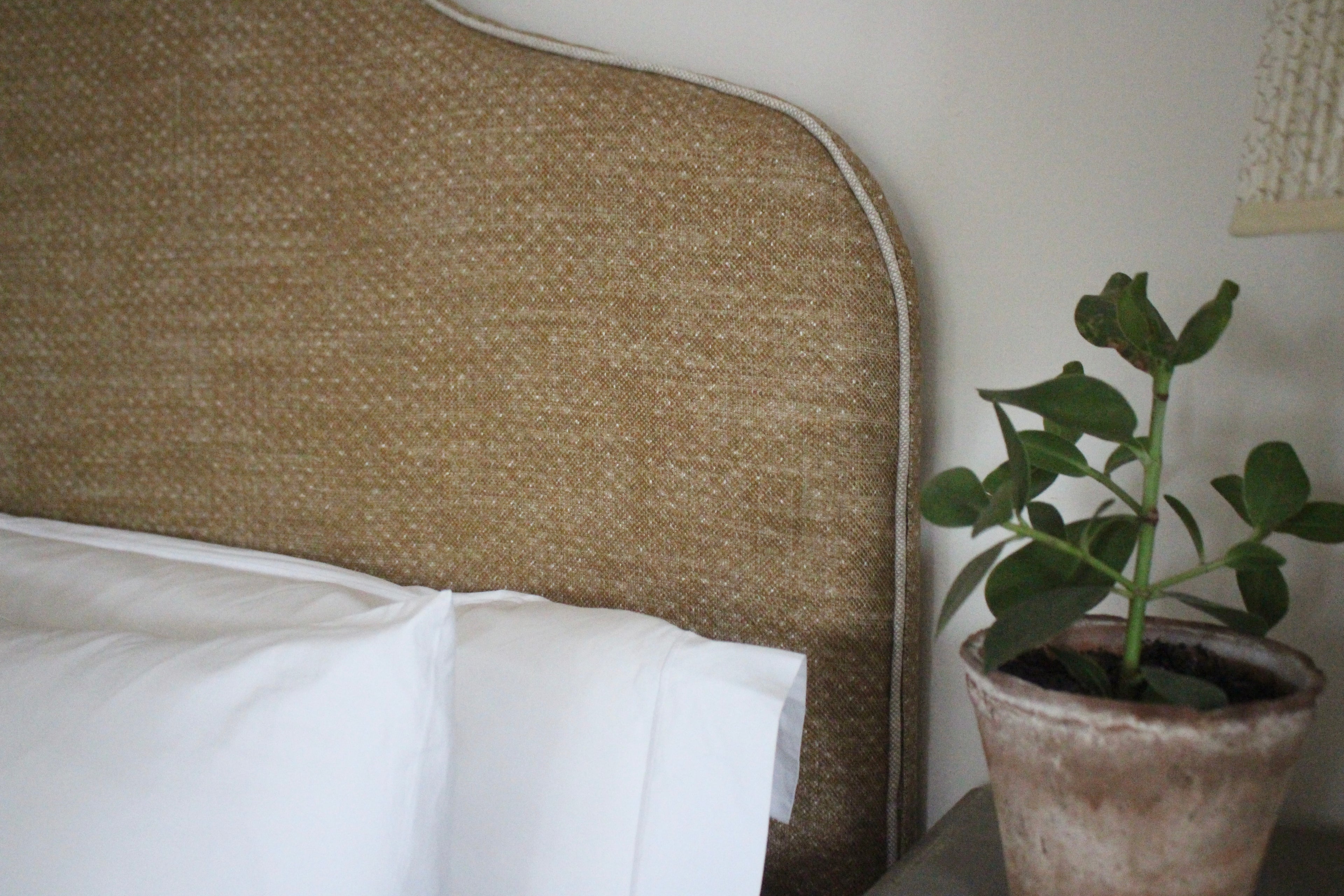 Close-up of Fermoie deep mustard fabric on handmade Margot king headboard